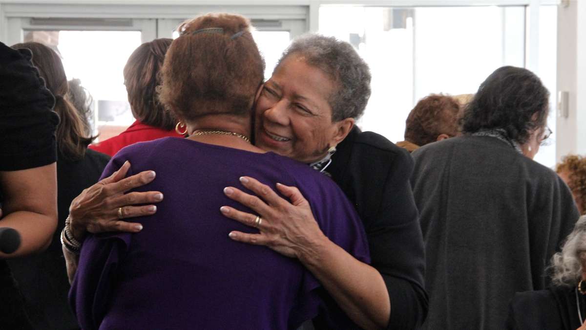 Mercy Douglass Alumni Association President Elizabeth Williams greets a former classmate at a tea honoring graduates of the historically black nursing school. (Emma Lee/for NewsWorks)