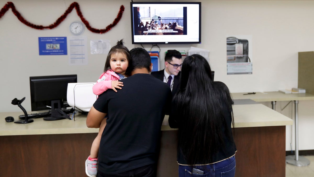  An official for the Consulate General of Mexico works with a family Friday, March 3, 2017, in San Diego, Calif. Mexican officials created of a new network aimed at informing and advocating for Mexicans living in the United States. The network, called the Mexican Defense Center, will bolster work for Mexicans at 50 consulates around the country, including Philadelphia. (AP Photo/Gregory Bull) 