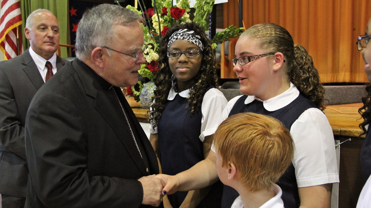  Archbishop Charles Chaput talks with St. Gabriel Elementary School students (from left) Amirah Drew, Caitlin Dwyer, and Joseph McCann after announcing that their school and 13 others will be independently run. (Emma Lee/for NewsWorks) 