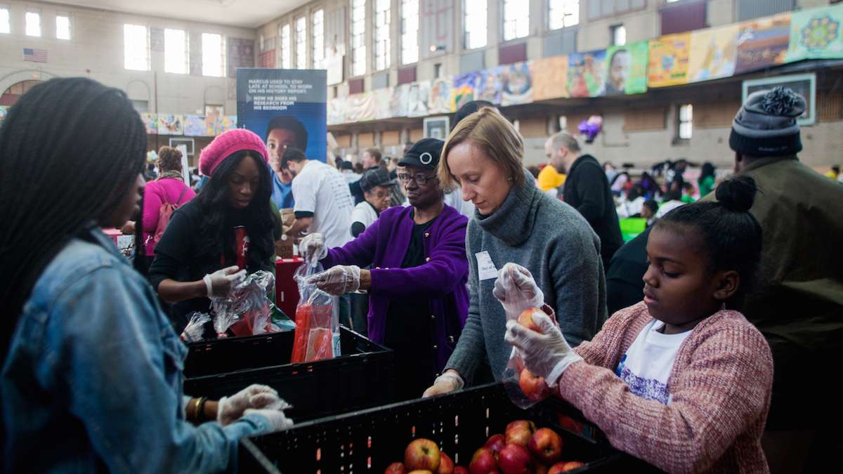 Volunteers with Philadbundance packaged apples at Girard College on Martin Luther King Day. (Brad Larrison for NewsWorks)