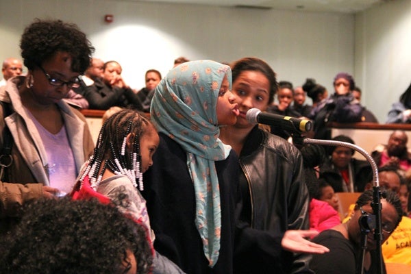 <p>In the crowded auditorium at Martin Luther King High School, Dobbins High School ninth grader Siani Whitehead urges administrators to keep her school open. (Emma Lee/for NewsWorks)</p>
