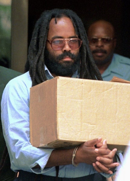 In this July 12, 1995 file photo, Mumia Abu-Jamal leaves Philadelphia's City Hall after a hearing. A federal judge in Pennsylvania has blasted a prison policy that denies former death-row inmate Abu-Jamal and others an expensive hepatitis C drug until they have advanced liver damage. Abu-Jamal is serving a life term for the 1981 killing of a Philadelphia police officer. He is a former Black Panther and radio reporter. (Chris Gardner/AP Photo, file)