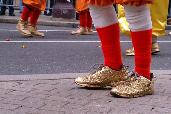 Mummers in golden slippers strut up Broad Street on New Year's Day 2013. (Peter Crimmins/WHYY)</p>
