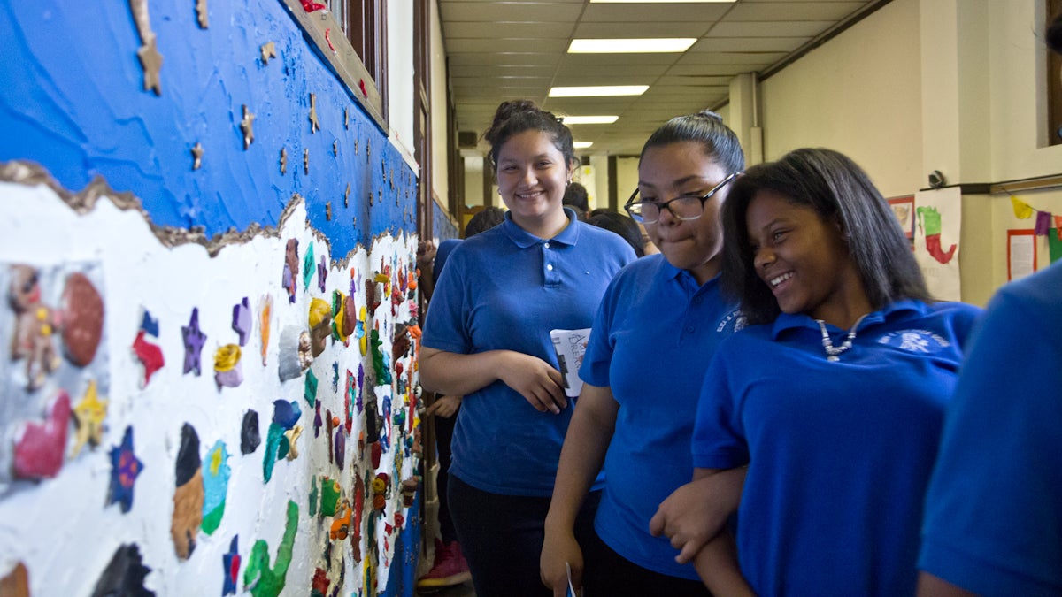  Margie Castejon (far left) stands by a mural created by eighth-grade students at South Philadelphia's Kirkbride School. 