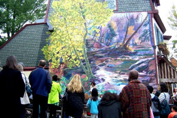 <p><p>Residents gathered outside of Bredenbeck's Bakery in Chestnut Hill on Saturday to admire the neighborhood's first mural. (Bob O'Brien/for NewsWorks)</p></p>
