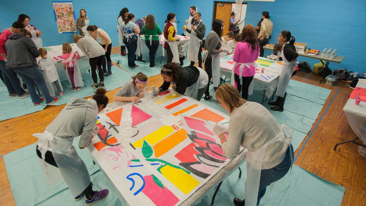 Nearly 50 volunteers participate in the mural painting at the Capitolo Playground Center.