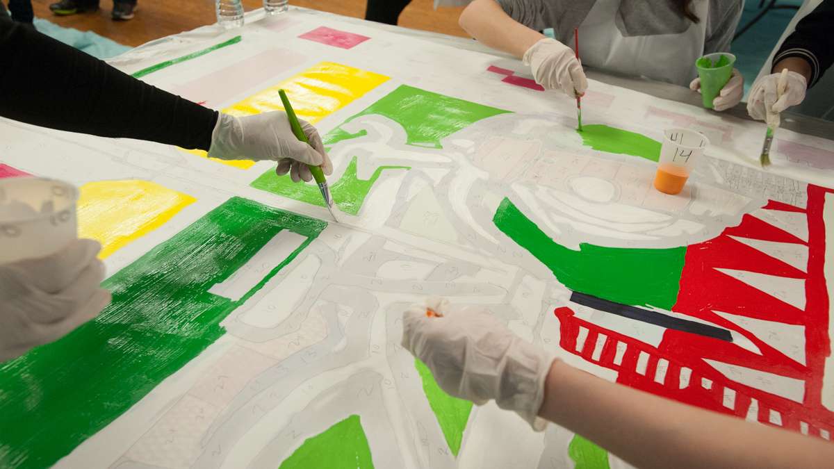 The paint-by-number canvases made painting the mural a simple process for the volunteers. (Jonathan Wilson for