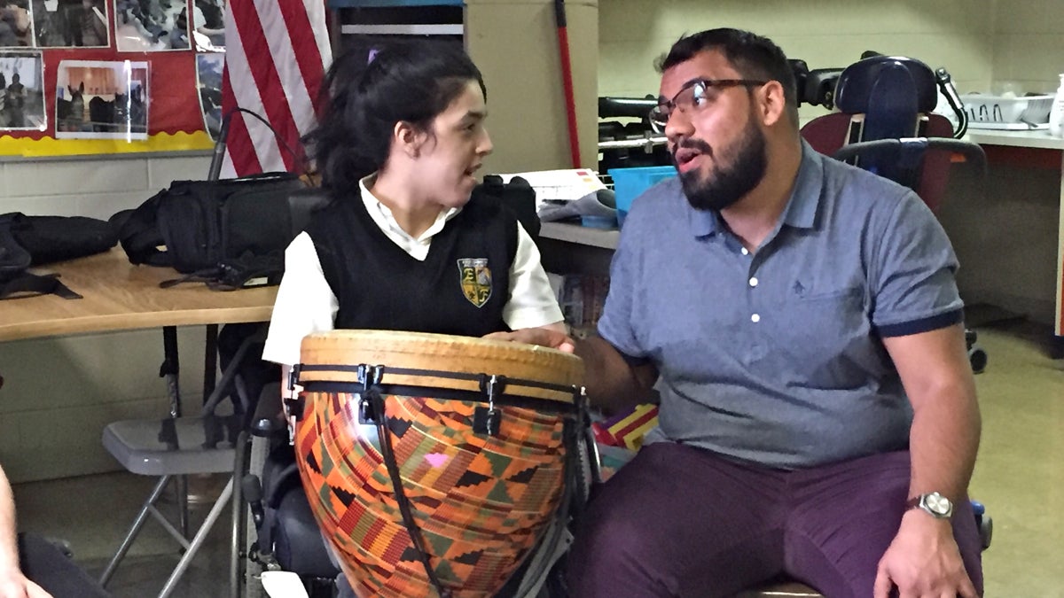  Juan Zambonini (right) sings with a student at Edison High School during a music therapy class. (Avi Wolfman-Arent/WHYY) 