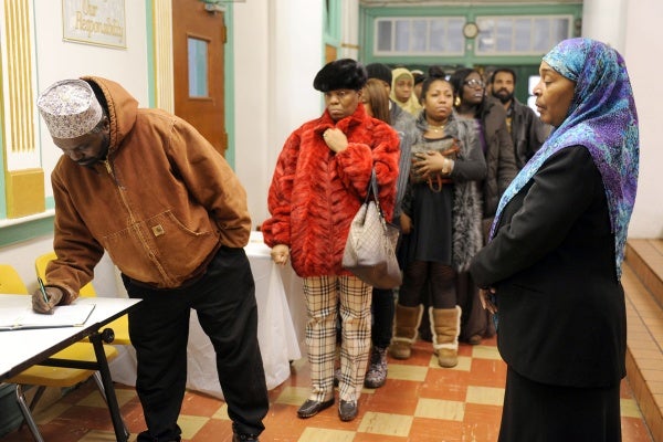 <p><p>Funeral director Khadijah Alderman, right, waits to direct people into the mosque. Alderman says four or five funerals every month are connected to violence. (Peter Tobia/for NewsWorks)</p></p>
