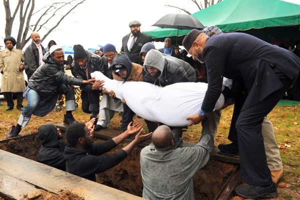 <p><p>The body of Najji Abdul-Rahim, wrapped in a white shroud according to Muslim tradition, is lowered into the resting place. (Peter Tobia/for NewsWorks)</p></p>
