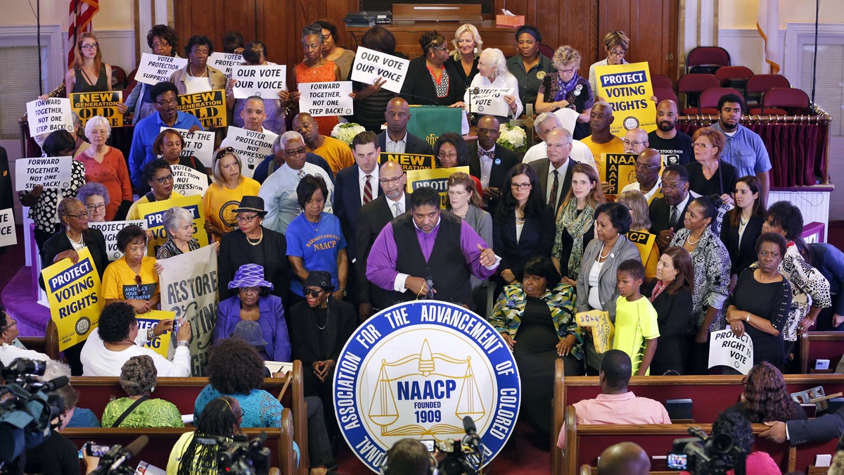  North Carolina NAACP president, Rev. William Barber, center at podium gestures as he is surrounded by supporters during a news conference at the Third Street Bethel AME Church in Richmond, Va., Tuesday, June 21, 2016. (AP Photo/Steve Helber) 