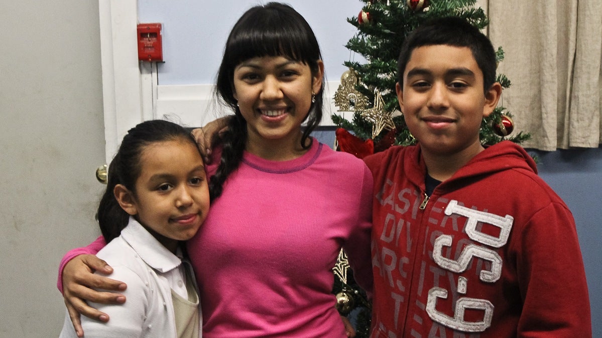 Angela Navarro and her children, 9 and 11, at the West Kensington Ministry. Both are U.S. Citizens. (Kimberly Paynter/WHYY)