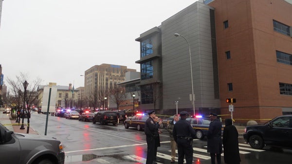 <p><p>Police gather outside the New Castle County Courthouse in Wilmington after the 8am shooting. (Mark Eichmann/WHYY)</p></p>

