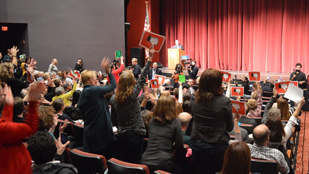  The crowd jeers U.S. Rep. Leonard Lance (R-7) at his latest town hall, held in the Nash Theater at Raritan Valley Community College in Branchburg on Wednesday. (Photo by NJ Spotlight) 
