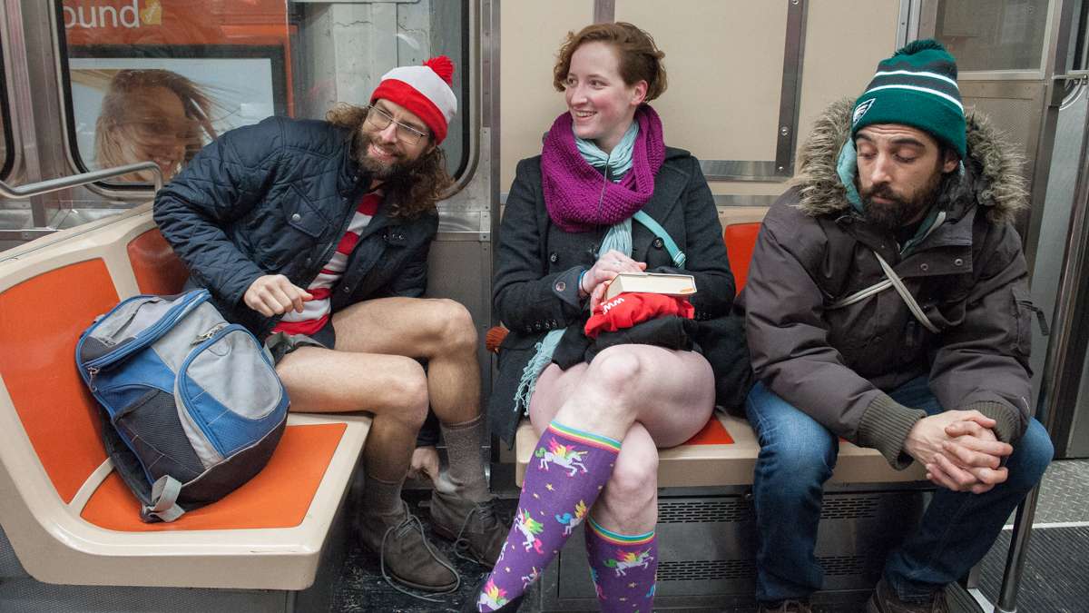 Friends who identified themselves as Waldo (left) and Koryn (center) participate in the No Pants Subway Ride on the Broad Street line.