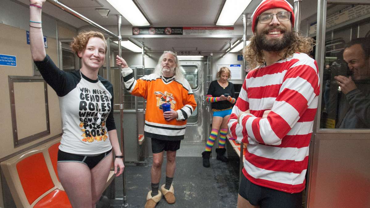 From left Koryn, Andrew Kerr, Peggy Kerr and Waldo watch the No Pants participants celebrating on the Broad Street subway.