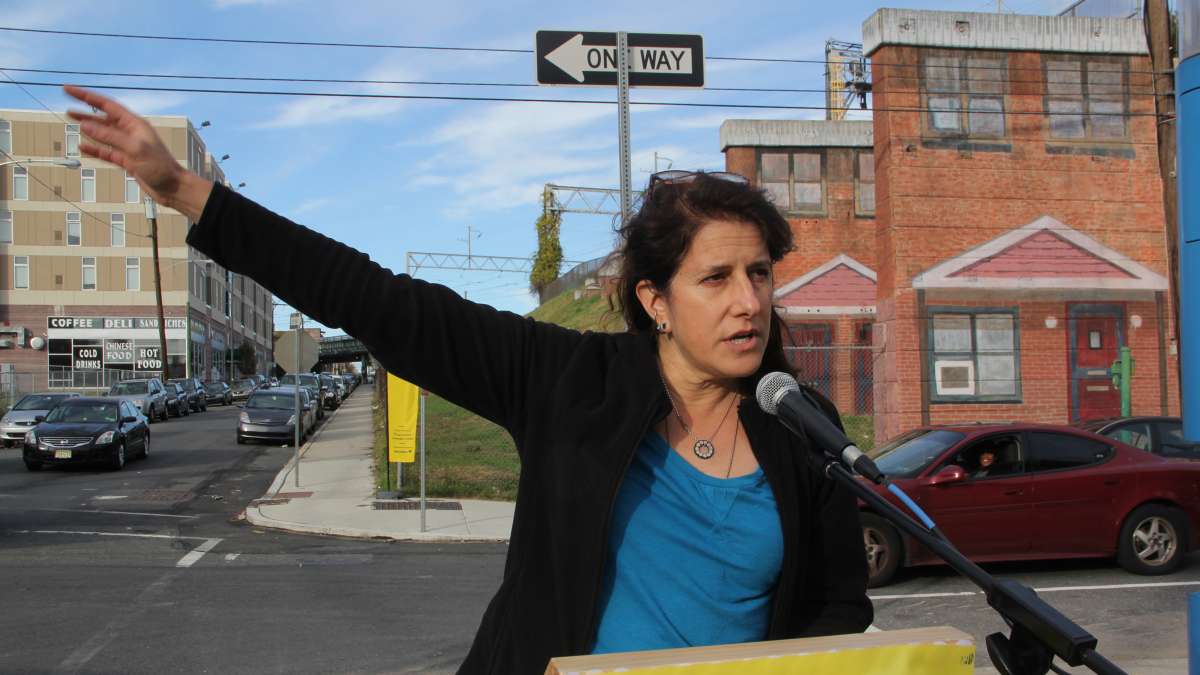 Artist Jennie Shanker speaks at the dedication of her work, Norris Homes Historical Marker, produced as part of the Mural Arts Open Source project. (Emma Lee/WHYY)