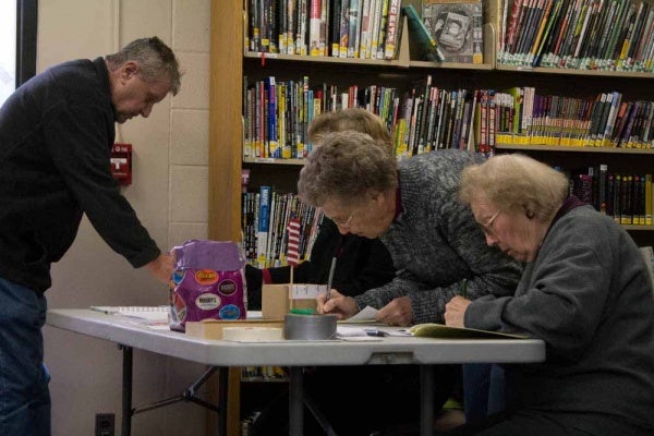 <p><p>Poll workers fill out the necessary paperwork at the Roxborough Library. (Francis Hilario/for NewsWorks)</p></p>
