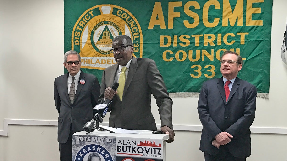  Peter Matthews, president of  District Council 33 of the American Federation of State, County and Municipal Employees, announces the union's support for Larry Krasner (left) in the race for Philadelphia district attorney and incumbent Alan Butkovitz (right) for city controller.  (Bobby Allyn/WHYY) 