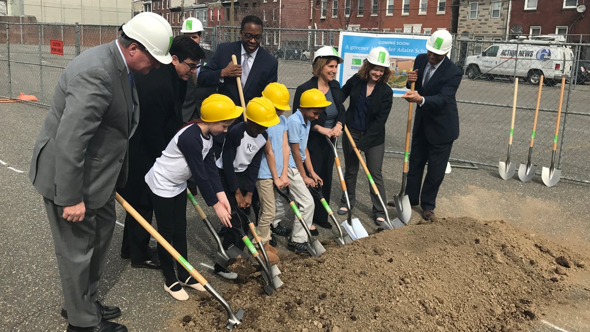  Philadelphia Mayor Jim Kenney, Council President Darrell Clarke, Schools Superintendent William Hite and others break ground for a schoolyard with students from the Alexander Adaire School, where the public green space will be located in Philadelphia's Fishtown section.  (Bobby Allyn/WHYY) 