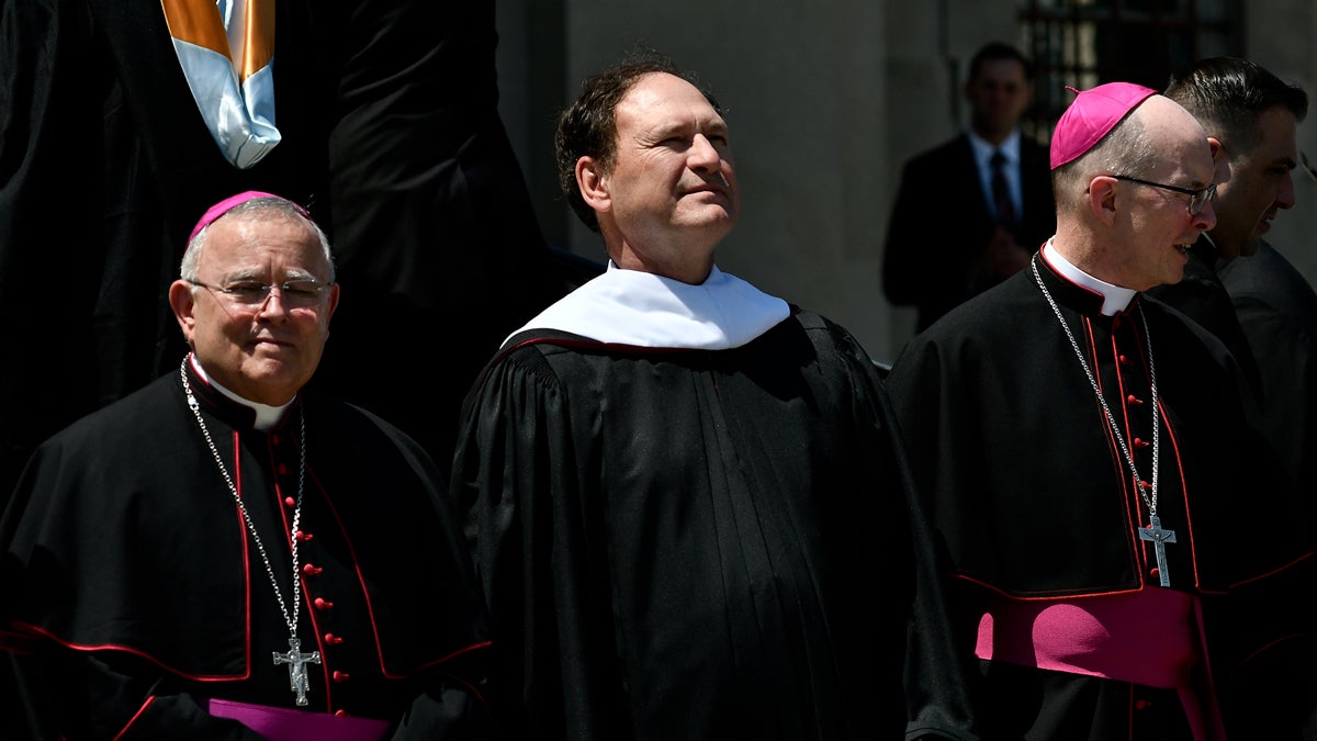 Graduates pose for pictures with U.S. Supreme Court Justice Samuel A. Alito in front of St. Martin of Tours Chapel, on Wednesday. (Bastiaan Slabbers for NewsWorks)