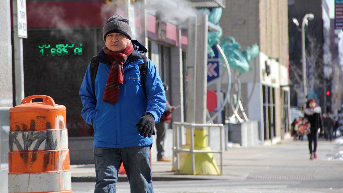  Bundled up against the extreme cold, a man crosses the street at Eighth  and Arch in Philadelphia (Emma Lee/WHYY) 