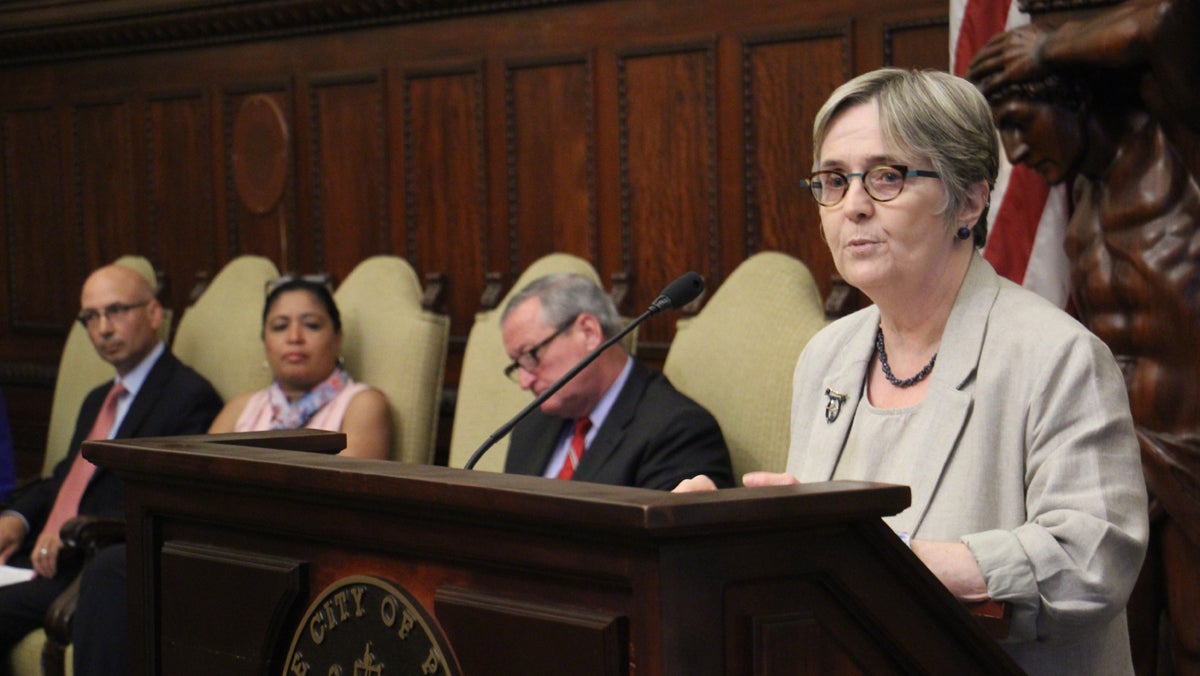  Philadelphia Water Department Commissioner Debra McCarty explains a new program that will help low-income residents reduce their water bills. (Emma Lee/WHYY)  