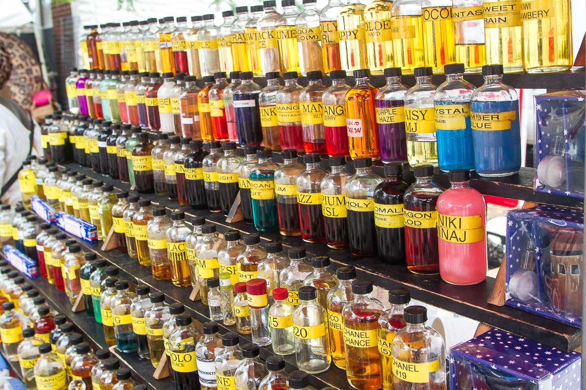 A dazzling array of colorful oils and perfumes are available for purchase in the marketplace at the Odunde Festival, including the Niki Minaj scent, at far right. (Brad Larrison/for NewsWorks)