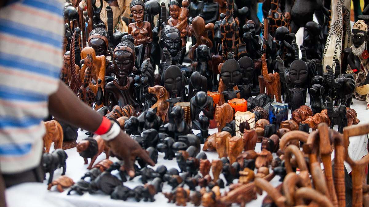 An array of hand-carved wooden statues and figurines are on display in the marketplace at the Odunde Festival. (Brad Larrison/for NewsWorks)