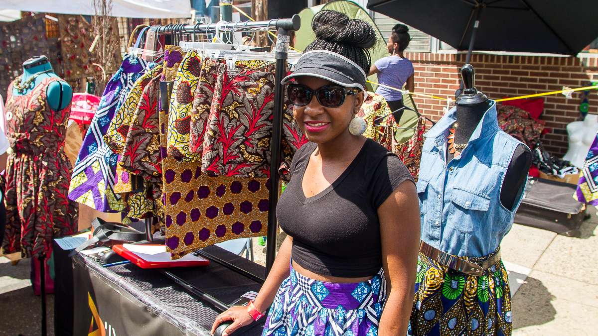 Nigerian born Addie Olutola displays her clothing line, D'iyanu, which is made in Philadelphia. Inspired by African traditional clothing usually worn only on special occasions, the clothes combine African fabrics with western looks, Olutola says. (Brad Larrison/for NewsWorks)