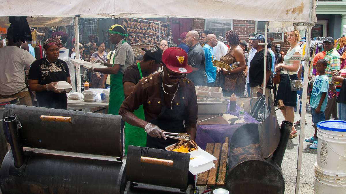 The Carribean Pot food stand serves up Jamaican dishes like curry goat and jerk chicken. The majority of food vendors sold Carribean and American soul food in many forms. (Brad Larrison/for NewsWorks)