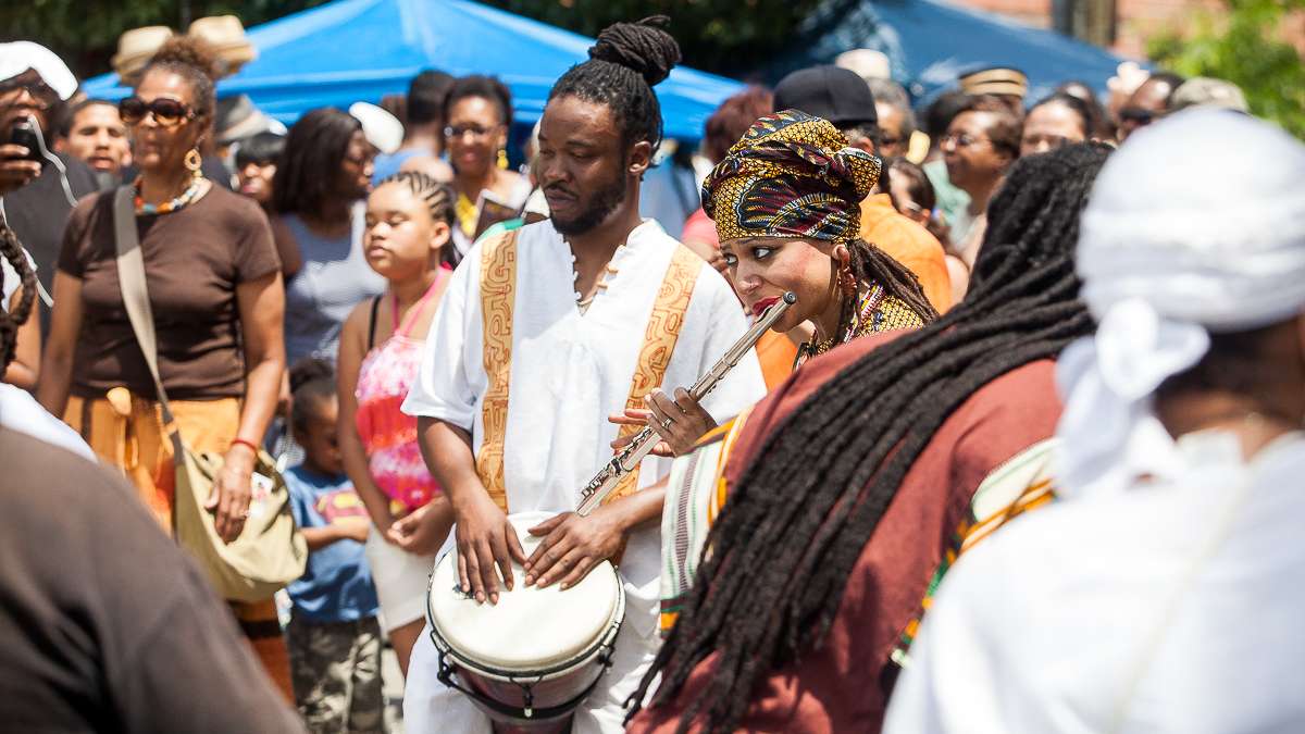 Musicians play before the start of a procession to the Schuylkill River during the Odunde Festival. (Brad Larrison/for NewsWorks)