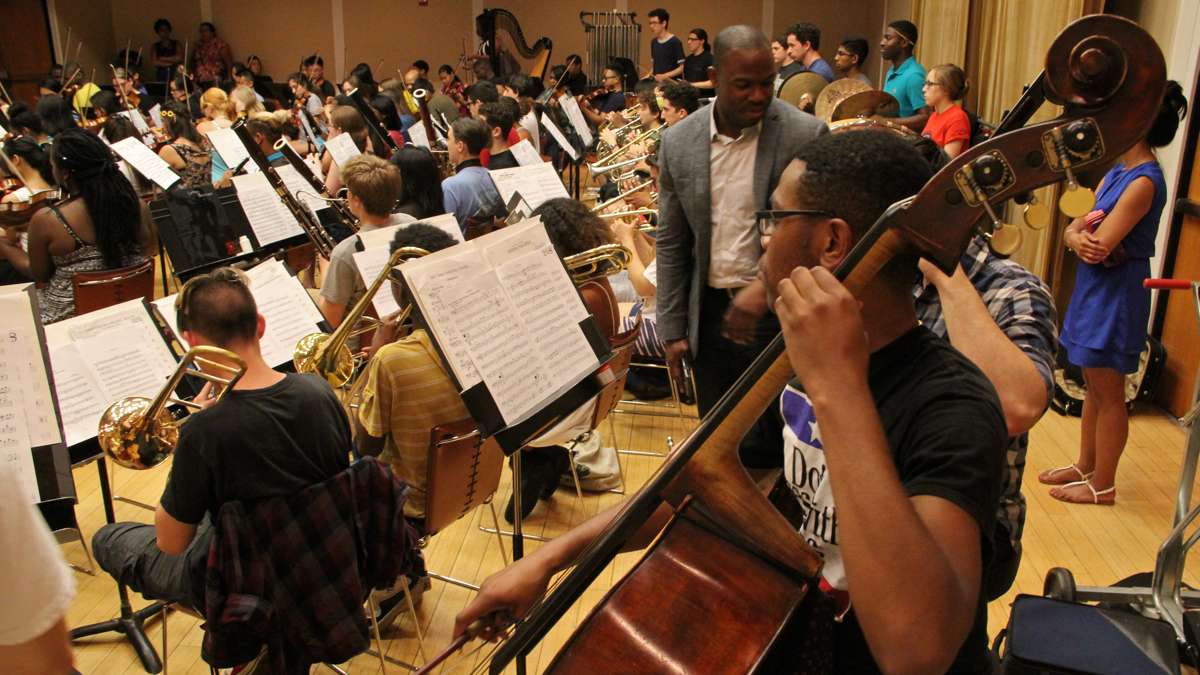 In a crowded practice room at the Kimmel Center, Philadelphia's All City Orchestra rehearses in preparation for a trip to Italy. (Emma Lee/WHYY)