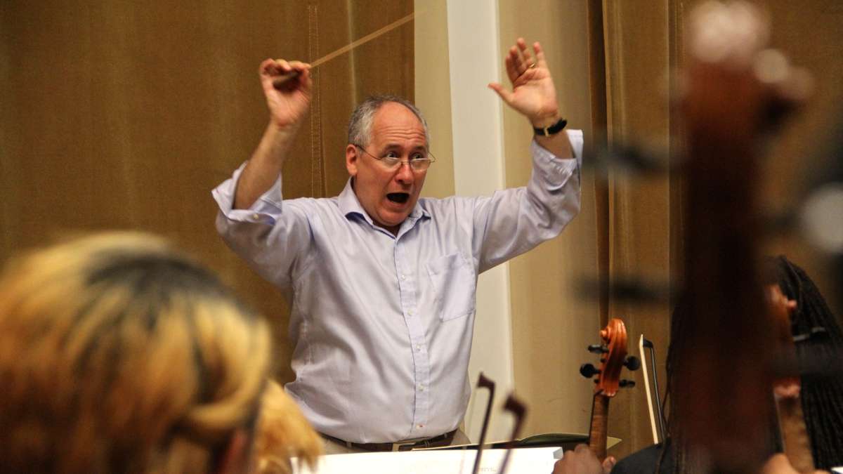 Don Liuzzi, principal percussionist for the Philadelphia Orchestra, conducts the All City Orchestra as they prepare for a trip to Italy. (Emma Lee/WHYY)