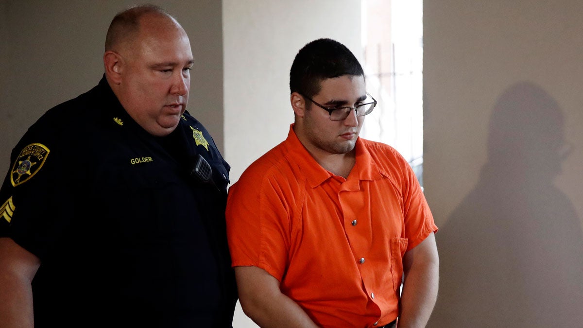  A law enforcement official escorts Cosmo DiNardo to a vehicle Thursday in Doylestown, Pa. Lawyer Paul Lang, a defense attorney for DiNardo, said Thursday that his client has admitted killing the four men who went missing last week and told authorities the location of the bodies. (AP Photo/Matt Rourke) 