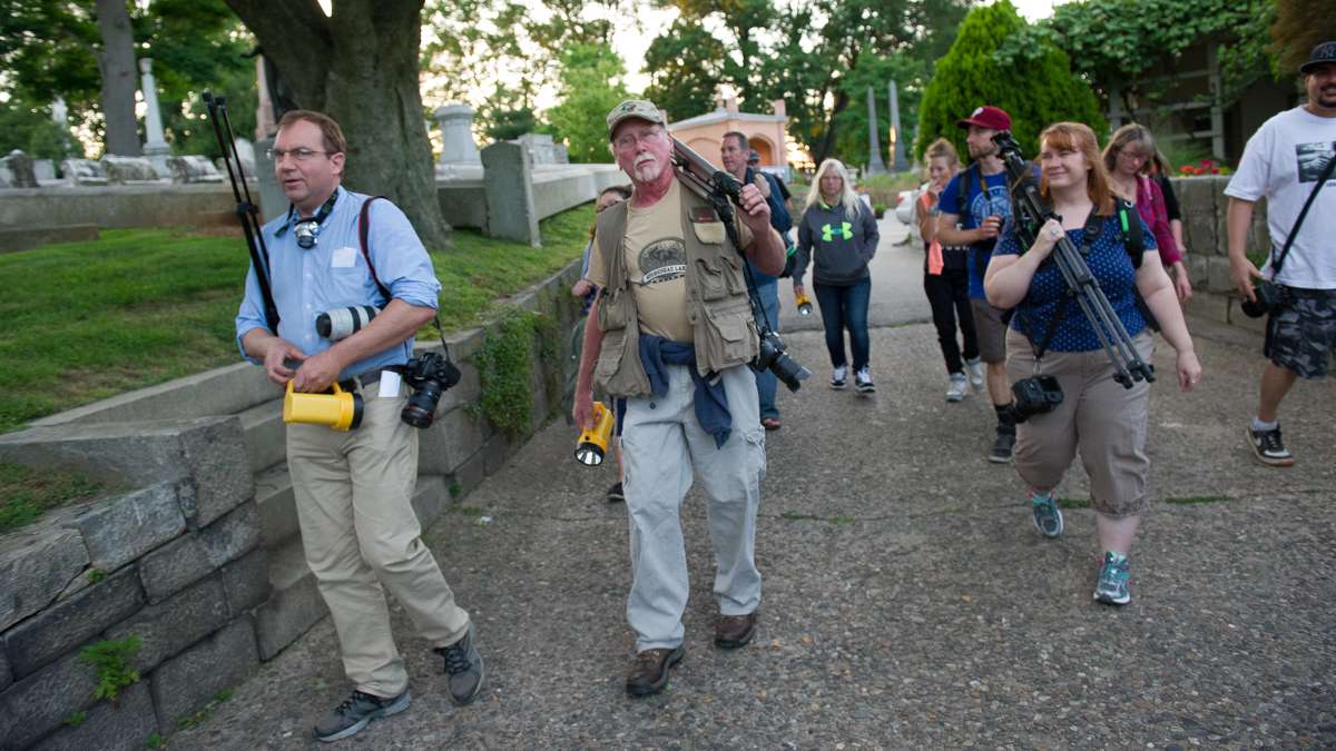 Laurel Hill Grounds Foreman Frank Rausch (second from left) leads more than a dozen photo enthusiasts through the cemetery at the start of the Lunar Stroll.