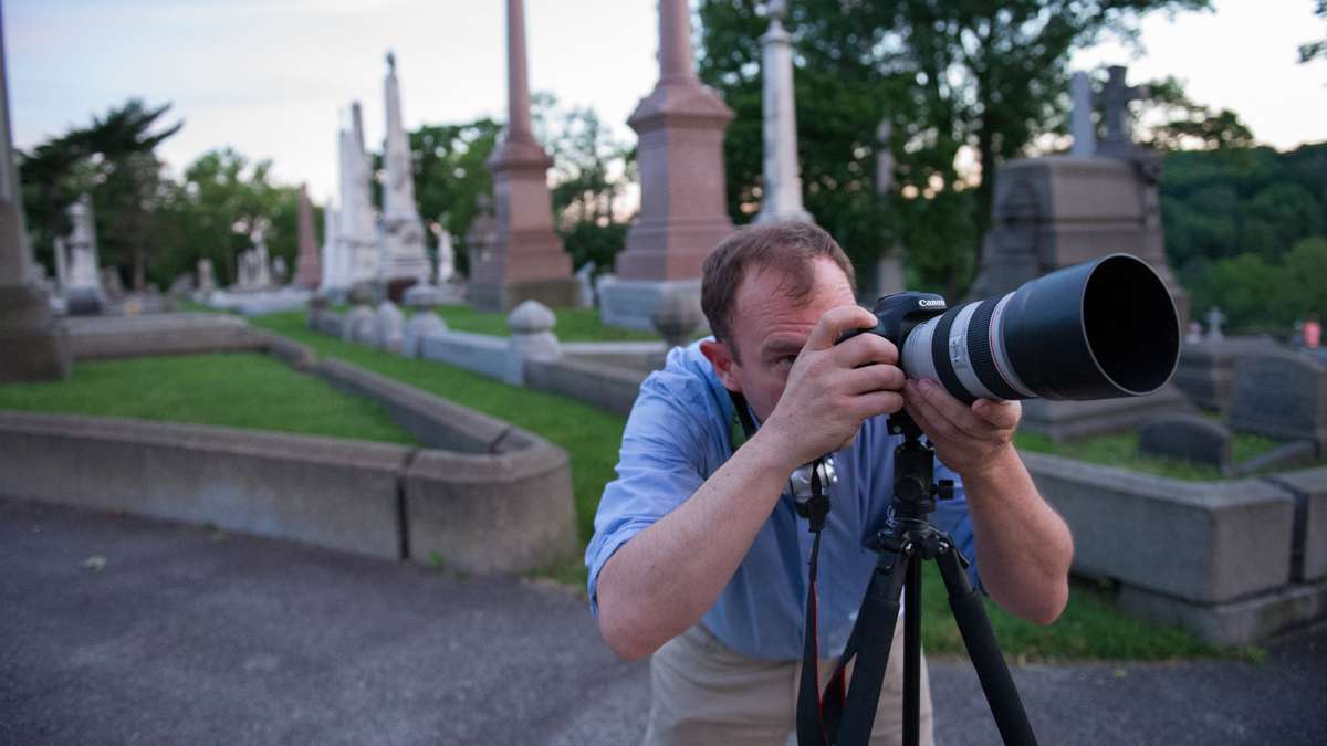 Michael Litchman trains his lens on one of the cemetery's monuments at sunset.