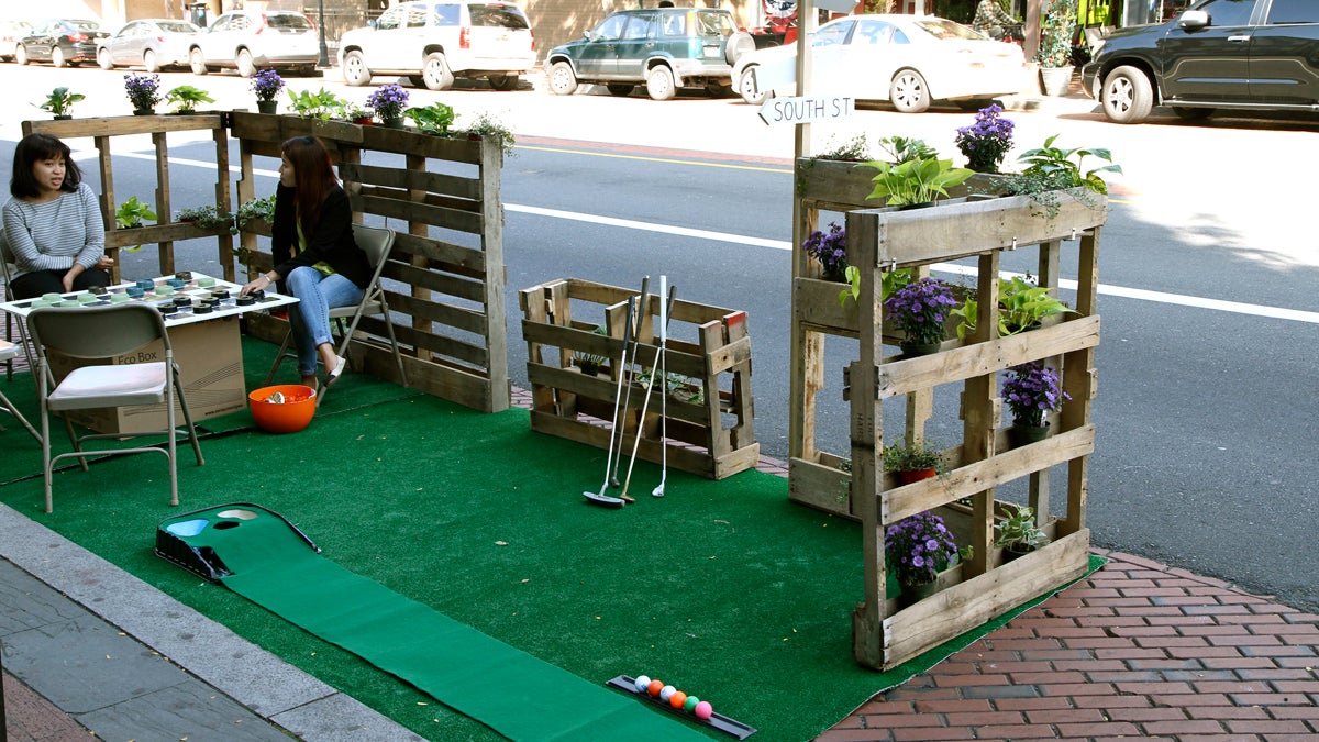 Relaxing after a one hole course. International Park(ing) Day pop up. (Charlie Kaier/WHYY)