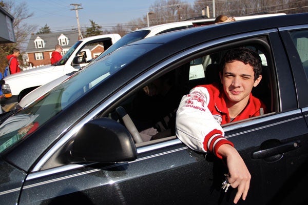 <p>Despite a shelter-in-place warning, John Gentile and other members of the Paulsboro High School wrestling team gather in a parking lot in Gibbstown while their coach tries to find a place for them to practice. (Emma Lee/for NewsWorks)</p>
