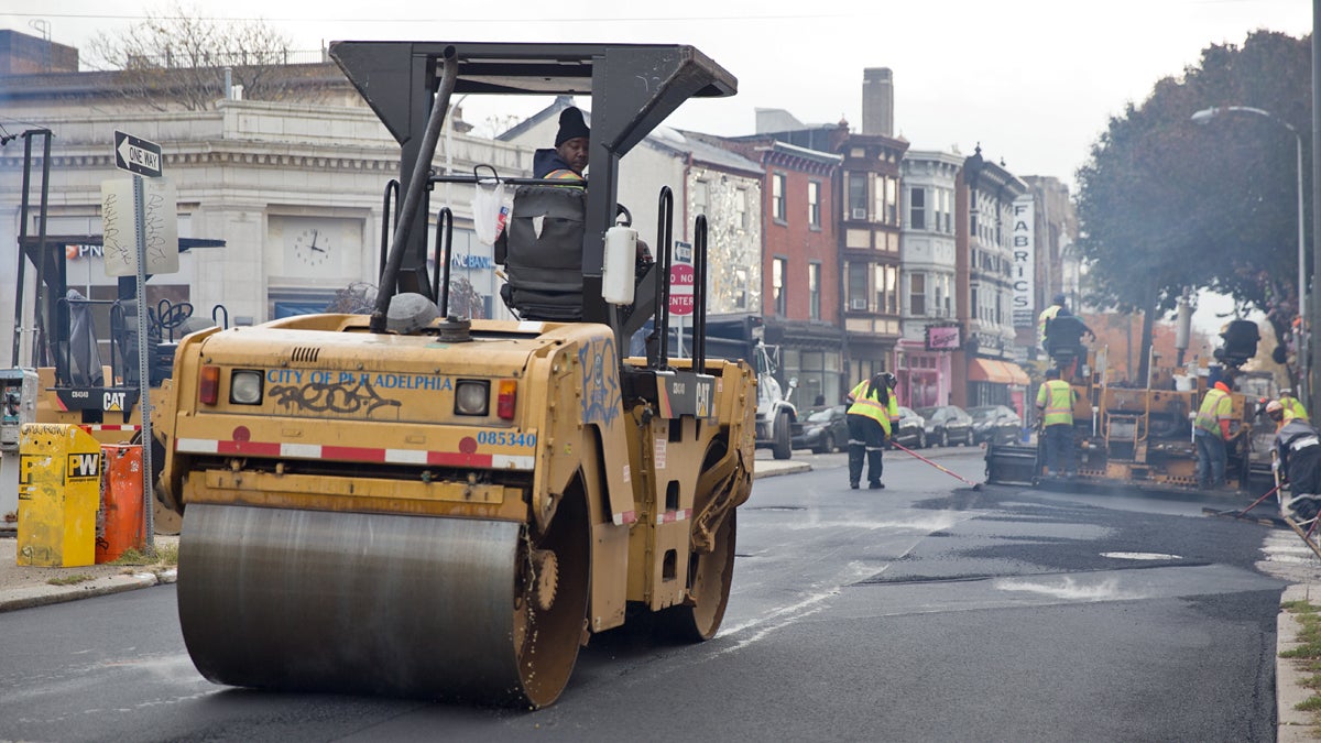 A road crew paves 5th Street in Philadelphia, Pa. (Lindsay Lazarski/WHYY) 