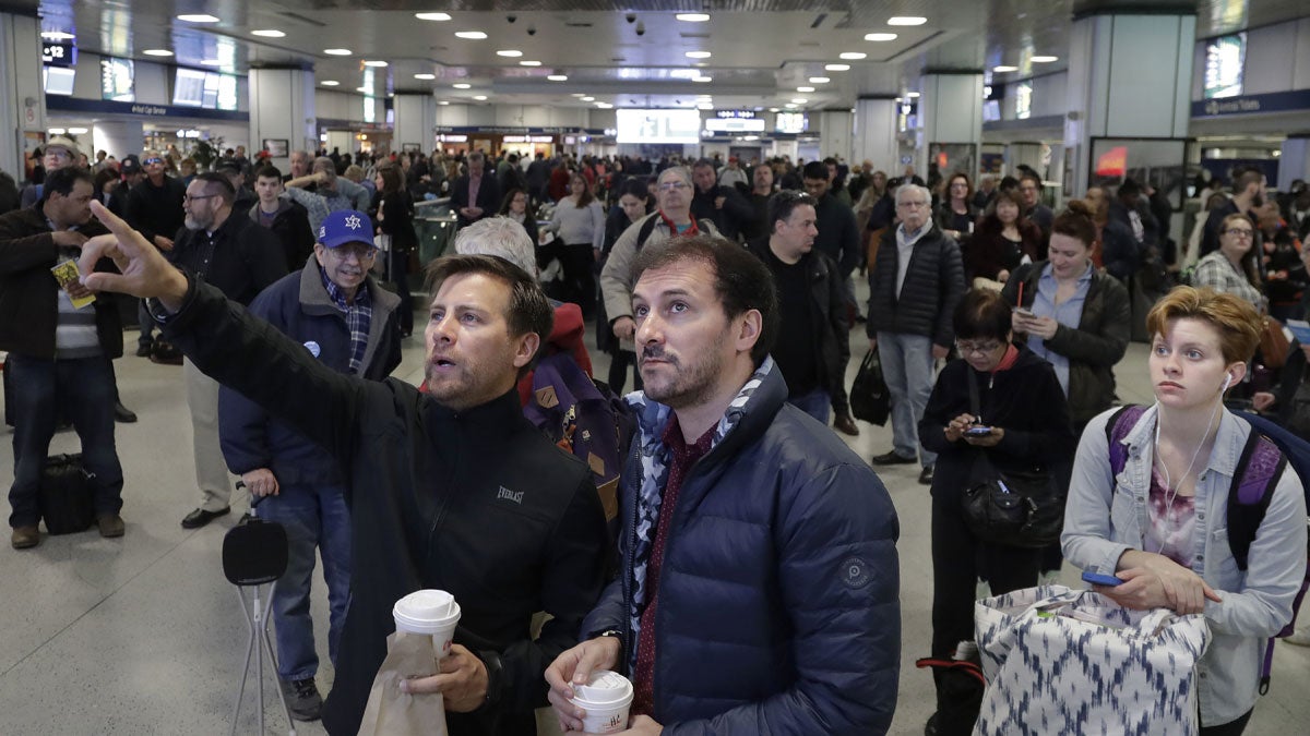  Passengers look up to a train schedule board while waiting in New York's Penn Station, Monday, April 3, 2017.  (AP Photo/Mark Lennihan) 