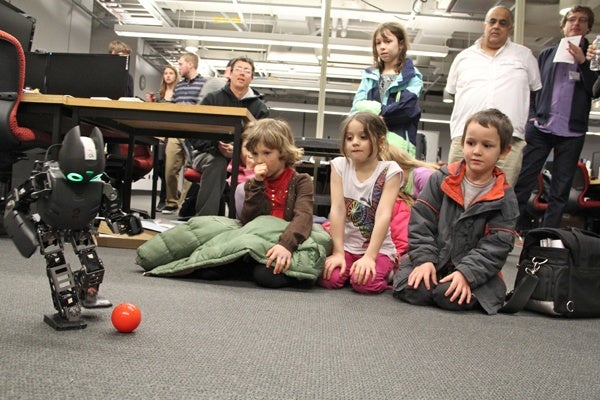 <p>Children watch Lucy, a soccer playing robot, during a break in the Y Prize competition at the University of Pennsylvania. (Emma Lee/for NewsWorks)</p>
