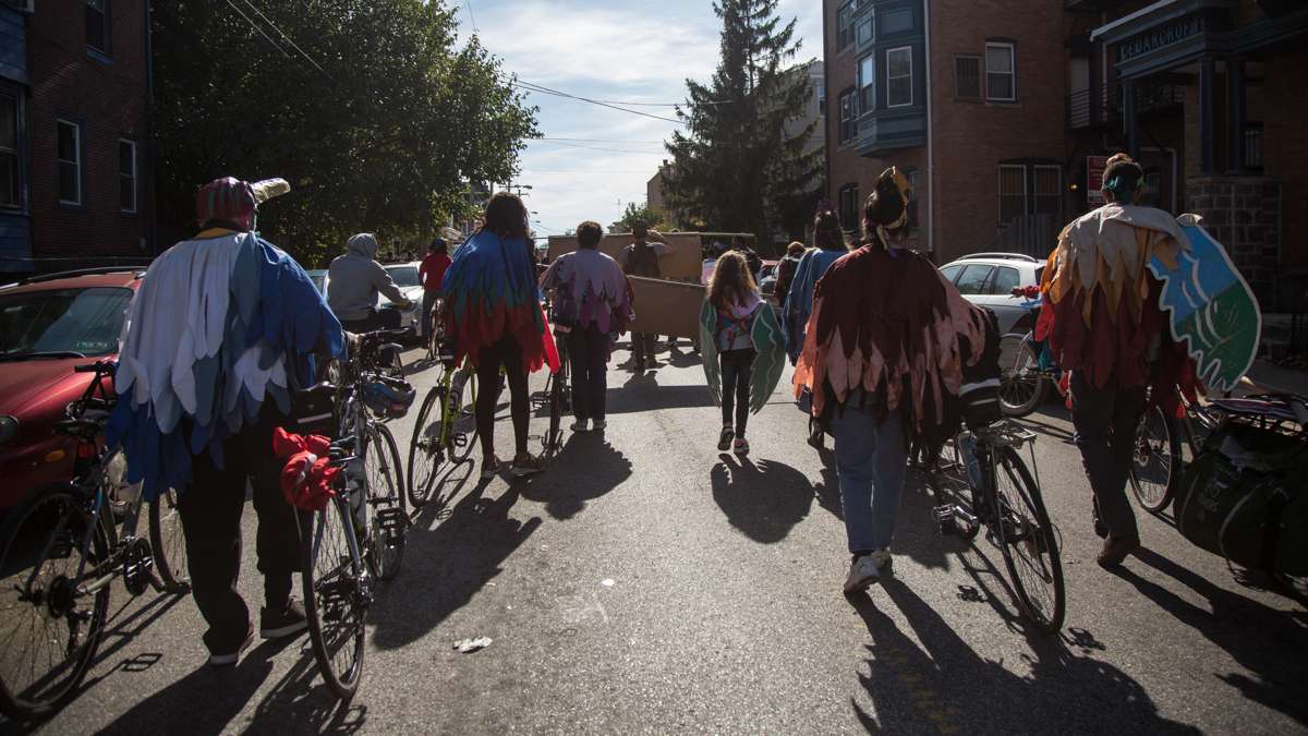 Members of the Neighborhood Bike Works delegation march as birds for the 17th annual Peoplehood parade in West Philadelphia, Oct. 29, 2016.