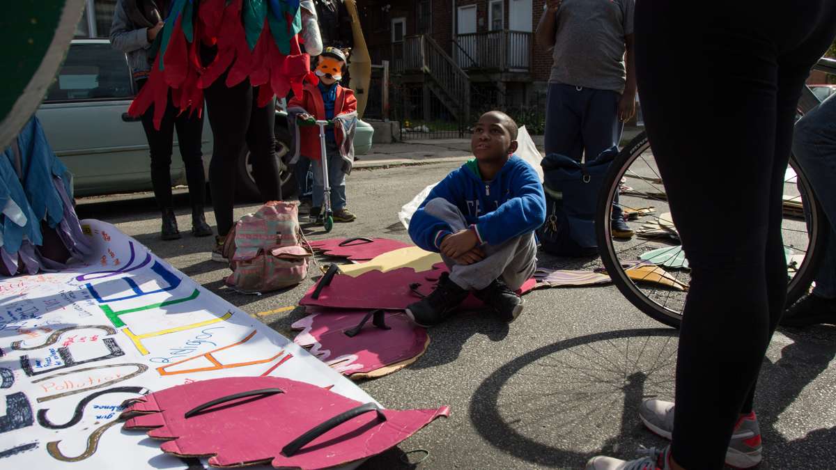 Asa Morrison, 10, discusses which issues matter to him at the Neighborhood Bike Works set-up spot before the 17th annual Peoplehood parade in West Philadelphia, October 29th 2016.