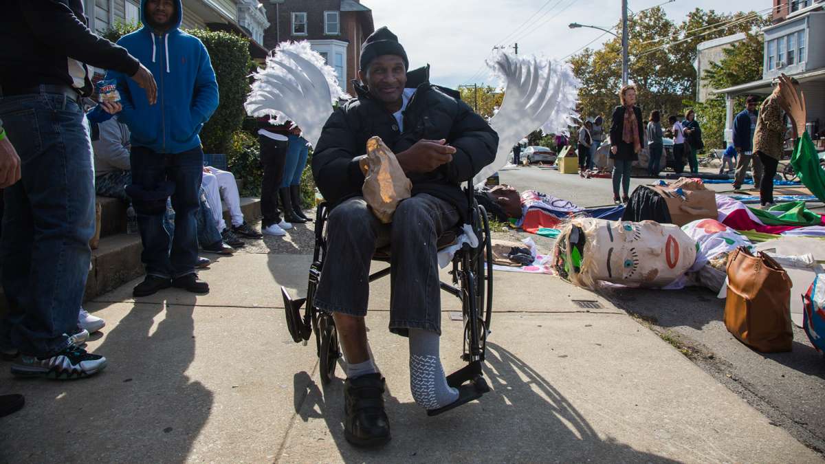 Dennis Cook sits in a chair decorated with angel wings to show of his support and gratitude to the organization Angels in Motion, which works with substance abusers and helps them get treatment.