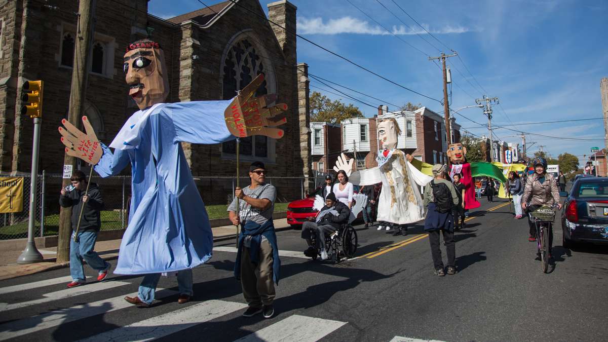 Representatives of Girard Medical Center carry the giant puppets they created for the 17th annual Peoplehood parade Oct. 29, 2016.