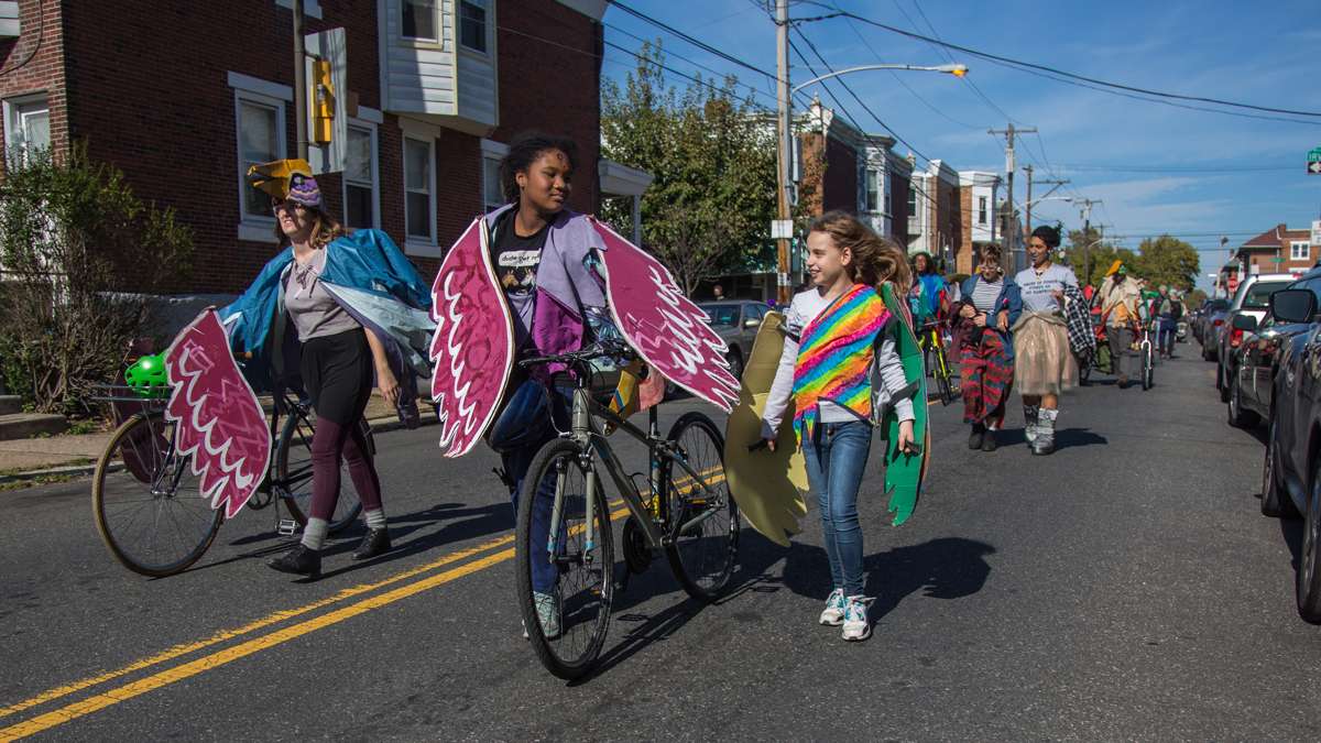 Young people from Neighborhood Bike Works chat as the 17th annual Peoplehood parade makes its way through West Philadelphia October 29th 2016.