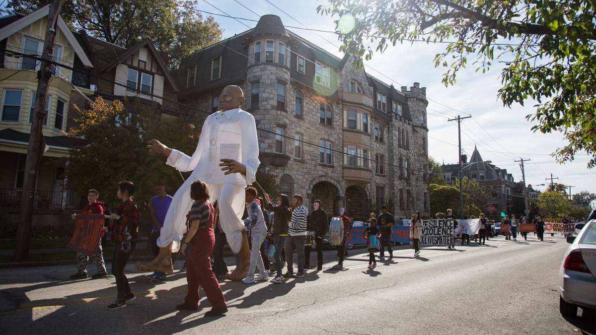 Social justice advocates march in the 17th annual Peoplehood parade Oct. 29, 2016, behind a giant puppet symbolizing the power of communities working together. (Emily Cohen for NewsWorks)