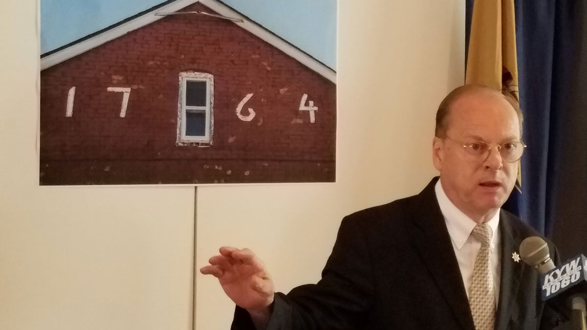 Chris Perks, president of the Camden County Historical Society, stood in front if an image of the Hugg-Harrison house. He filed a lawsuit against the NJDOT. (Peter Crimmins/WHYY) 