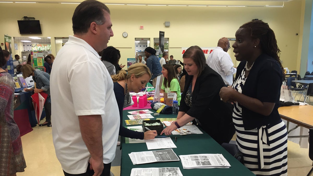  Phillip DeLuca, principal at Samuel Gompers school, is shown talking to a potential nonprofit partner at the School District of Philadelphia's annual Partnership Fair. (Avi Wolfman-Arent) 
